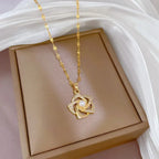 Stainless Steel Golden-Plated Micro-Set Synthetic Zirconia & Rotating Floral Pendant Necklace.