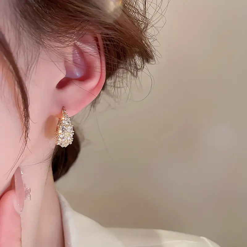 Elegant and luxurious 14K gold-plated earrings set with shiny Zirconia -.