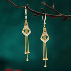 Elegant Golden Geometric Tassel Earrings with Sparkling Cubic Zirconia.