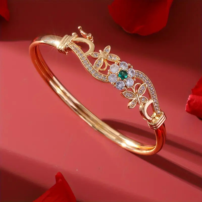 legant Golden-Tone Butterfly Open Bangle Bracelet with Sparkling Synthetic Zirconia & Floral Design.