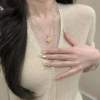 Vintage Style Twisted Double-Sided Clover Necklace with 18K Golden Plated Copper and Synthetic Zirconia -.